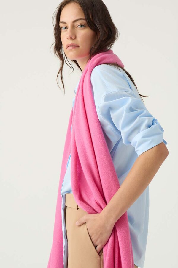 Woman wears Cashmere Travel Wrap in Carnation