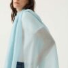 Woman wears Cashmere Featherweight Scarf in Sky Blue