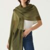 Featherweight scarf in rich olive worn by woman