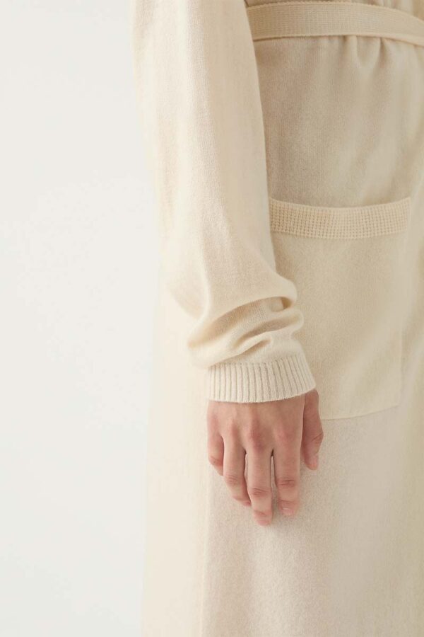 Woman wears ivory cashmere robe with close up of sleeve