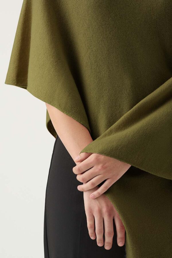 Woman wears cashmere poncho in Olive Green