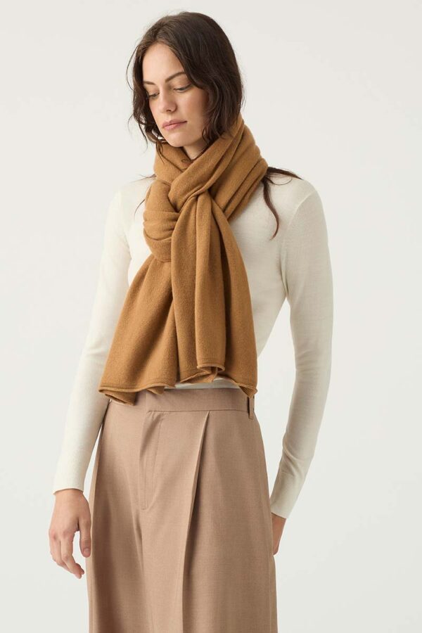 woman wears cashmere travel wrap in spice