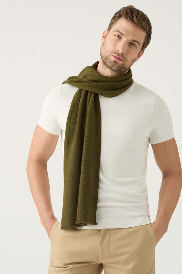 Man wears olive cashmere scarf casullay around his neck
