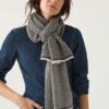 Woman wears Striking woven scarf in navy and light taupe