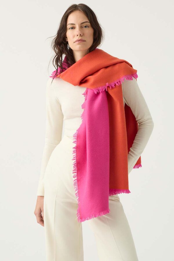 Woman wears Indian Rose and Tangerine coloured Cashmere Wrap