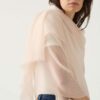 Woman wears featherweight cashmere in blush