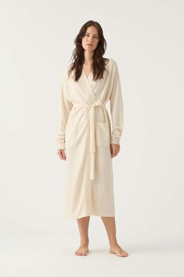 woman wears cashmere robe in ivory